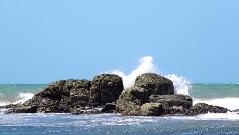 Waves-crashing-against-rocks,-Patagonia,-Argentina,-slow-motion-wide-shot