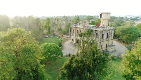 A-landscape-aerial-view-of-Chittorgarh-fort,-a-UNESCO-world-heritage-site,-Rajasthan,-India,-Fort-smog-over-city,-Aerial-view,-11
