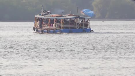 A-Ferry-boat-full-of-passengers-moving-towards-shore-in-middle-of-the-bay-video-background-in-Full-HD