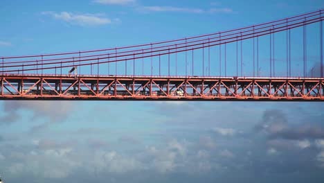 SLOW-MOTION:-Train-moving-on-25th-of-April-Bridge-in-Lisbon,-Portugal
