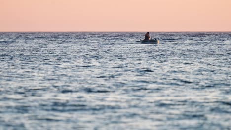 Local-fisherman-in-small-fishing-boat-off-Croatian-coast-at-sunset