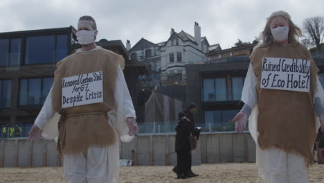 Eco-protesters-stand-outside-the-Carbis-Bay-Hotel-in-St