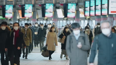 Tokyo,-Japan---Slow-Motion-Of-People-Wearing-Hygiene-Facemasks-Walking-Inside-Shinagawa-Station-During-Pandemic---Medium-Shot