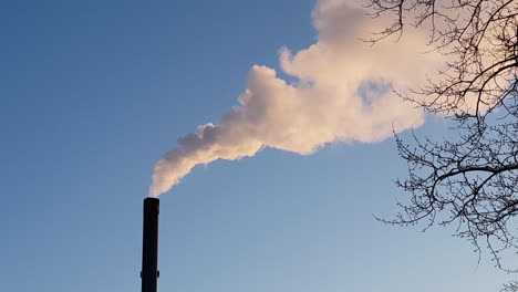 Massive-pollution-from-industry-chimney-isolated-of-beautiful-blue-sky