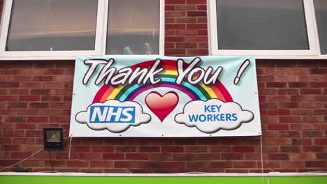 Thank-You-NHS-and-Key-Workers-banner-sign-outside-shop-for-covid-pandemic-work