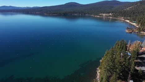 Drone-footage-of-lake-Tahoe,-North-Shore-beach-and-trees