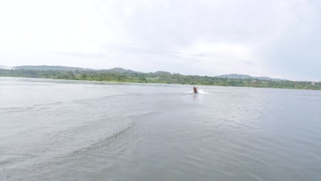 A-man-goes-down-an-epic-water-slide-on-the-river-Nile-on-his-stomach-and-skims-along-the-water-on-a-bodyboard