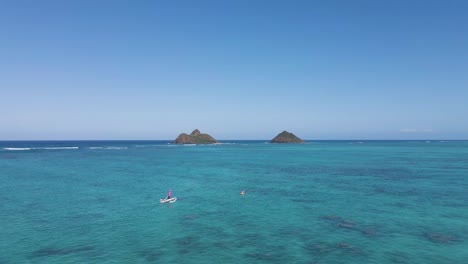 Aerial-View-Of-Outrigger-Sailing-Towards-Mokulua-Islands,-Oahu,-Hawaii