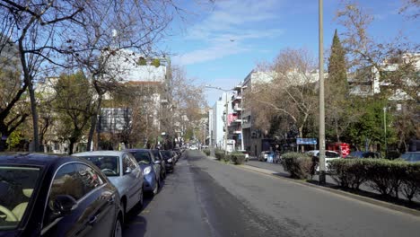 Tilt-down-establishing-shot-of-Frantzi-street,-one-of-the-busiest-streets-of-Athens,-deserted-during-coronavirus-lockdown-traffic-restrictions