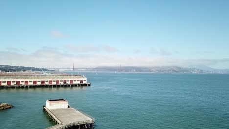 Aerial-ascending-above-water-port-to-reveal-the-Golden-Gate-Bridge-in-the-background