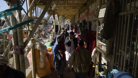 Locals-Walking-On-Sidewalks-Passing-By-Stall-Shops-At-Midday-On-Bamyan,-Afghanistan