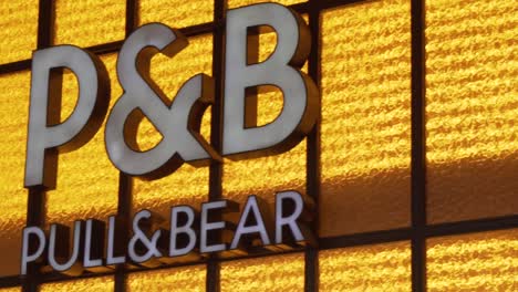 Slow-motion-pan-of-the-Pull-and-Bear-logo-on-the-front-of-the-shop
