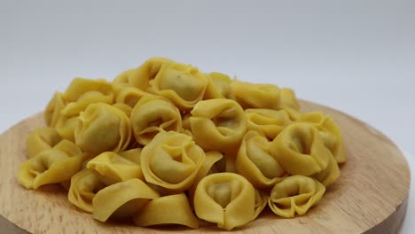 Raw-tortellini-on-rotating-display-isolated-on-white