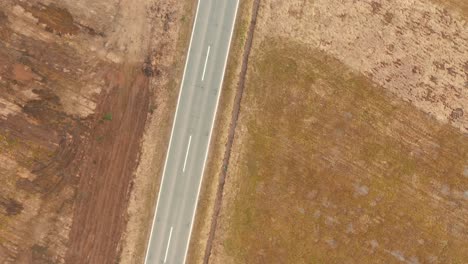 Above-the-road-where-cars-driving,-zoom-in,-Drone-4K-colored