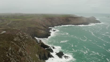 Aerial-along-the-Atlantic-shore-and-into-the-mist,-Cornwall,-England,-part-of-the-scenery-used-in-the-Masterpiece-Theater-presentation-of-Poldark