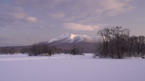 Breathtaking-view-out-over-frozen-lake-at-Onuma-Koen-with-mountain-in-distance