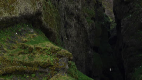 Large-crevasse-in-mountain,-Snaefellsnes-Peninsula,-Iceland,-medium-shot-tilt-up