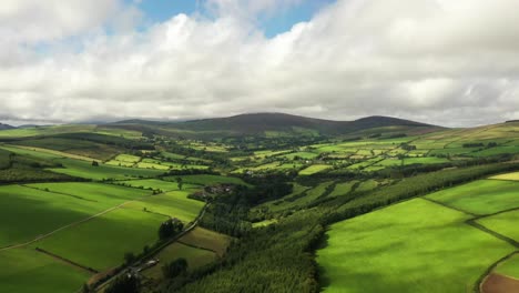Irish-rural-landscape,-Aughrim,-Wicklow-August-2020,-Drone-gradually-pushes-forward,-facing-North-towards-Ballycreen-Upper-hills
