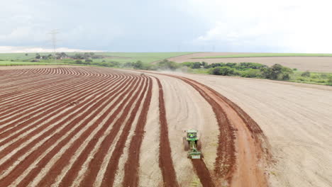 Tractor-plowing-the-land,-preparing-the-soil-for-planting