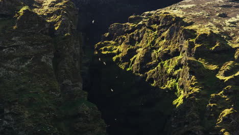 Crevasse-in-sunny-mountains,-Snaefellsnes-Peninsula,-Iceland,-wide-shot-zoom-in