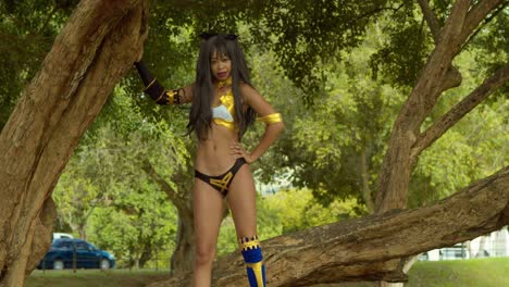 Ishtar-from-fate-grand-order-cosplayer-girl-on-a-large-tree-branch
