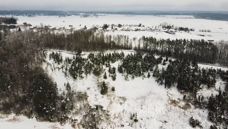 Flying-towards-hillside-viewpoint-path-covered-in-white-snow