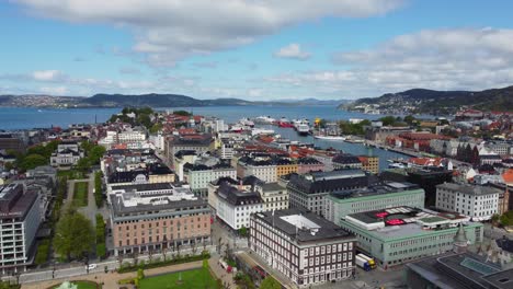 Beautiful-aerial-Bergen-city-from-Festplassen-park-and-viewing-Bryggen-with-seafront-and-Askoy-island-in-background---Forward-moving-aerial