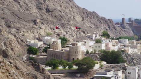 The-Al-Hajar-Mountains-and-Old-Muscat,-Oman,-wide-shot-pan-right
