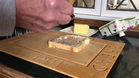 Toast-having-butter-and-cherry-jam-spread-on-it-in-the-kitchen-of-an-Oakham-dwelling-place-in-the-county-of-Rutland-in-England,-United-Kingdom
