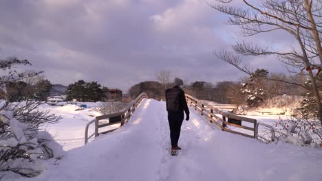 Male-hiker-walking-through-stunning-snowy-landscape