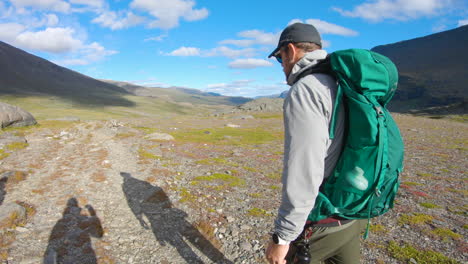 Close-up-of-a-male-hiker-walking-in-the-nature-of-Northern-Sweden-in-slow-motion