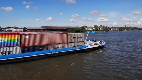 Cargo-Ship-With-Maersk-Containers-Passes-By-The-Kinderdijk-Village-In-Molenlanden,-Netherlands