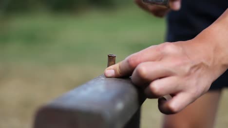 Blacksmith-Hammering-a-Bullet-on-Anvil,-Metalsmith-Workshop,-Close-Up