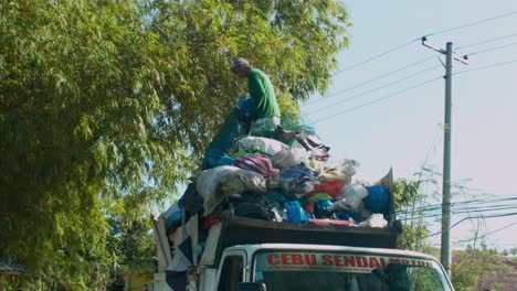 Garbage-collector-catches-sack-of-rubbish