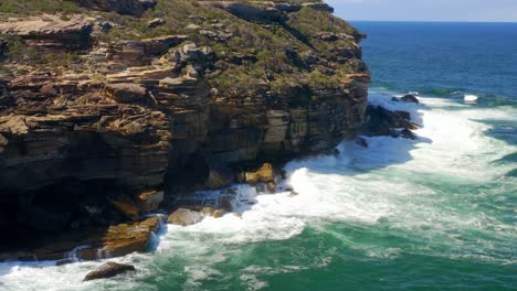 Sandstone-Coastal-Cliffs-With-Raging-Waves-At-Royal-National-Park-In-South-Of-Sydney,-New-South-Wales,-Australia