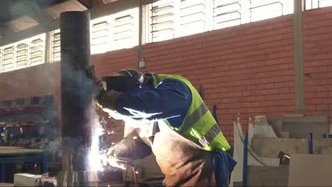 Worker-welding-a-metal-peace-in-an-industrial-space