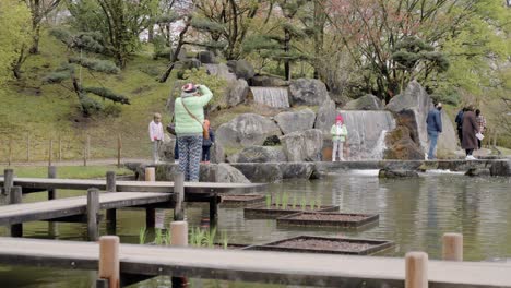 Tourists-taking-pictures-in-the-biggest-Japanese-garden-of-Europe-in-Hasselt,-Belgium
