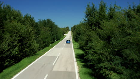 Audi-A3-Sportback-Car-Driving-On-A-Long-Straight-Road-Between-Green-Trees-In-Istria,-Croatia