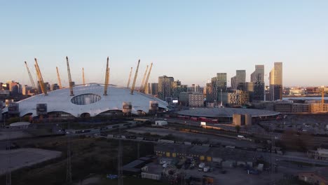 Aerial---The-O2-Arena-and-Canary-Wharf,-London,-UK,-wide-angle-pan-right