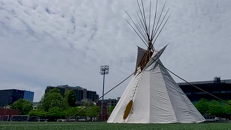 Clouds-pass-over-teepee-at-Indigenous-Vaccine-Clinic-on-Varsity-Field,-University-of-Toronto,-Toronto,-June-19,-2021