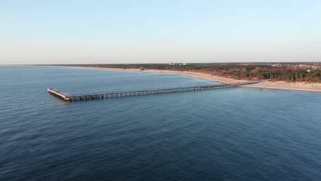 AERIAL:-Palanga-Bridge-with-Baltic-Sea-in-the-Evening-with-Beach-and-Forest-in-Background
