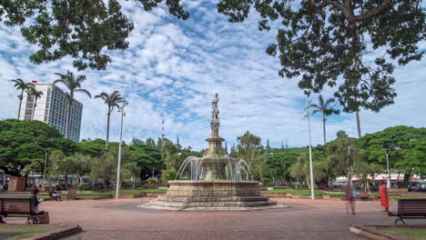 Time-lapse-view-of-people-at-the-fountain-of-Coconut-Tree-Square,-in-sunny-Noumea