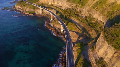 Vehicles-Driving-On-Sea-Cliff-Bridge-On-A-Sunny-Day-In-Clifton,-Australia