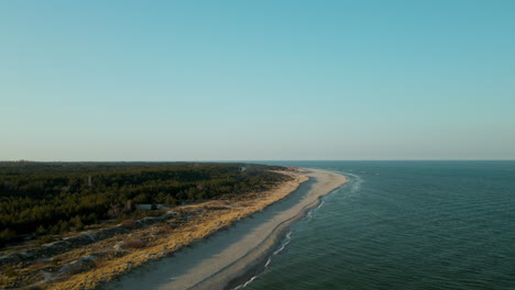 Beautiful-drone-flight-over-waves-crashing-on-beach-coast-in-Hel-Poland