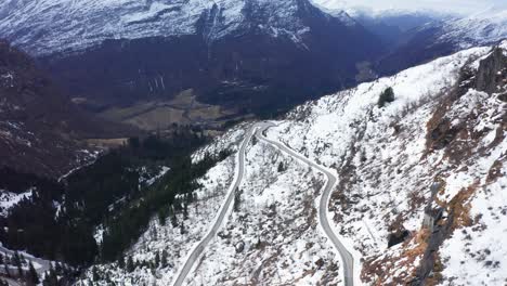 Spectacular-winding-roads-climbing-up-mountainside-in-enticing-snow-alps-of-Teigdalen-Norway