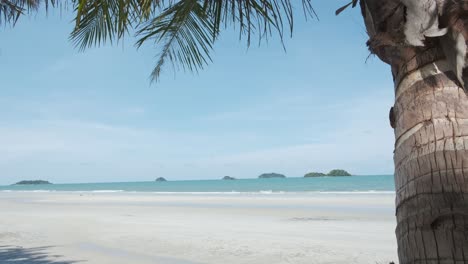 Tropical-white-sand-beach-with-ocean-and-far-away-islands
