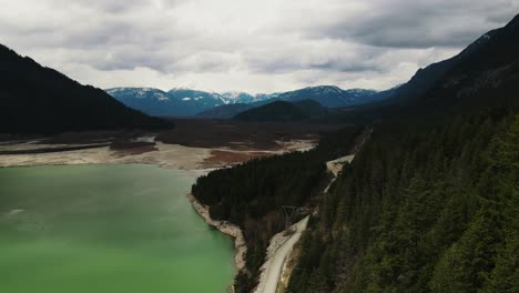 Slow-aerial-drone-shot-of-trees-and-Lillooet-Lake-in-British-Columbia,-Canada