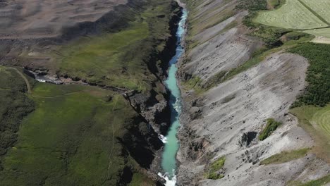 High-above-famous-Studlagil-gorge-with-stunning-blue-water-river,-Iceland