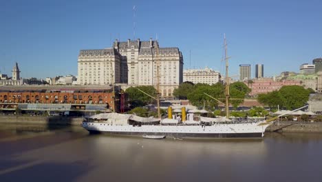 Aerial-push-in-view-of-Sarmiento-Frigate-in-Puerto-Madero,-Buenos-Aires