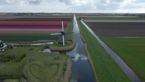 Traditional-Dutch-windmill-Molen-P-in-scenic-rural-landscape,-aerial